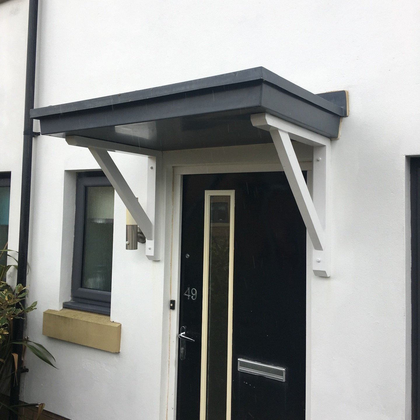 Flat roof door canopy with our Straight brace gallows brackets for support